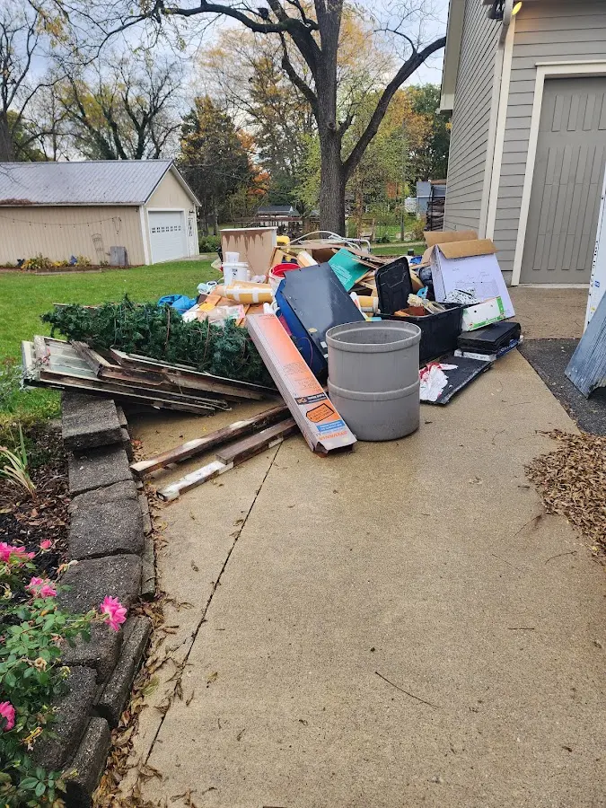Dumpster being loaded with debris for Roofing Dumpster Rental in Bardstown